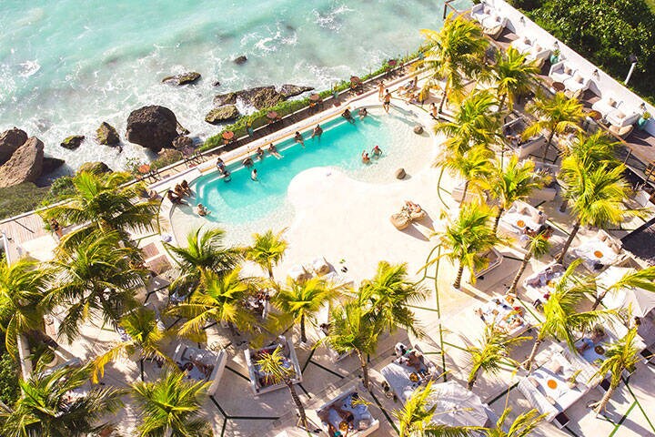 Aerial view of swimming pool overlooking ocean at El Kabron Beach Club, Bali