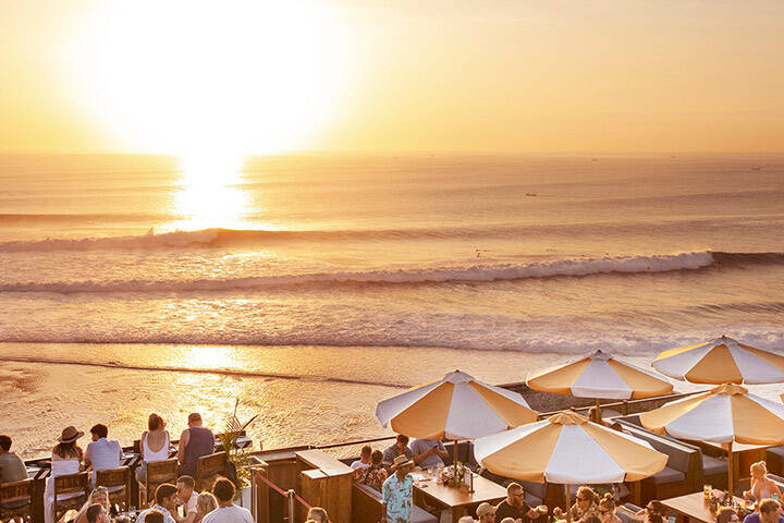 Outdoor beer garden overlooking ocean at Single Fin Beach Club, Bali
