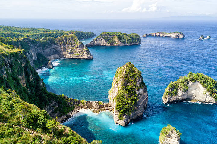 Aerial view of the small island of Nusa Batumategan and  Nusa Batupadasan Island from the Atuh Rija Lima shrine on Nusa Penida Island near Bali, Indonesia.