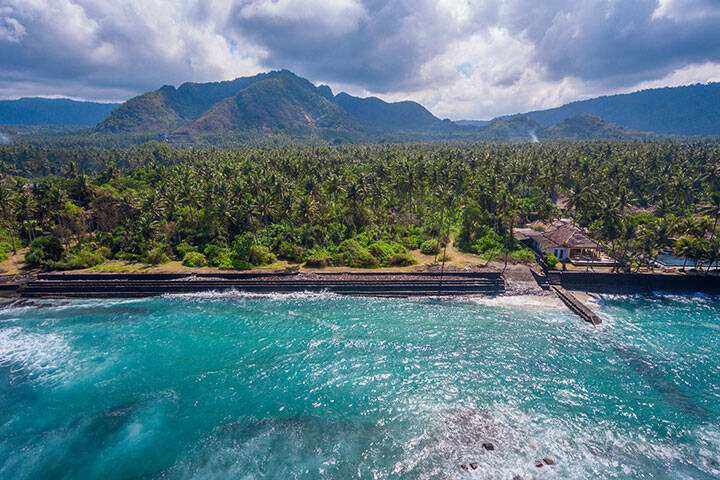An aerial panoramic view on Candi Dasa shoreline on Bali island in Indonesia 