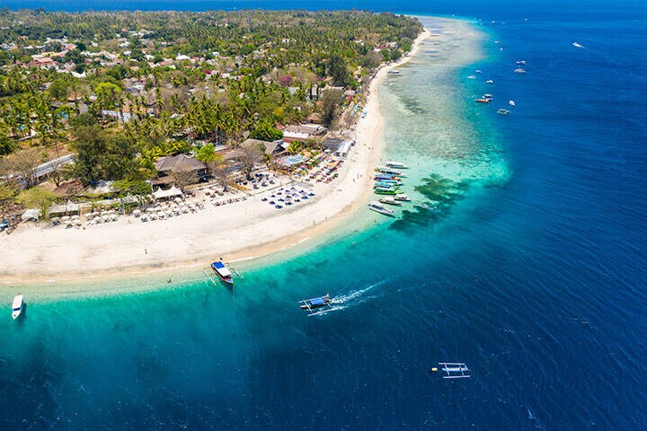 Aerial drone view of a beautiful tropical beach and coral reef on a small island (Gili Air, Indonesia)