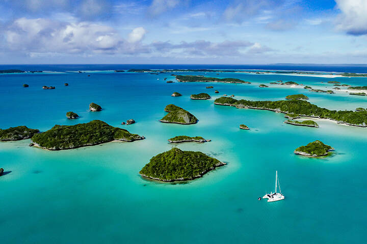 A spectacular  drone  image over Falaga Island in the lower Lau Group, Fiji showing a catamaran peacefully at anchor.