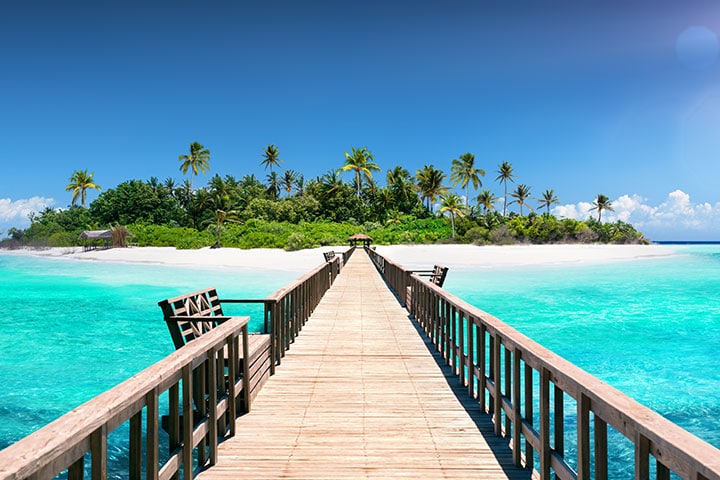 Pier heading towards island in Maldives