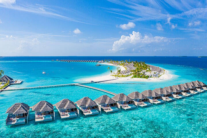 Aerial landscape, of Maldives, with a luxury tropical resort of water villas and beautiful beach scenery