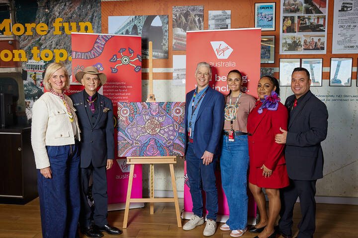 First Nations group performing traditional dance at event.