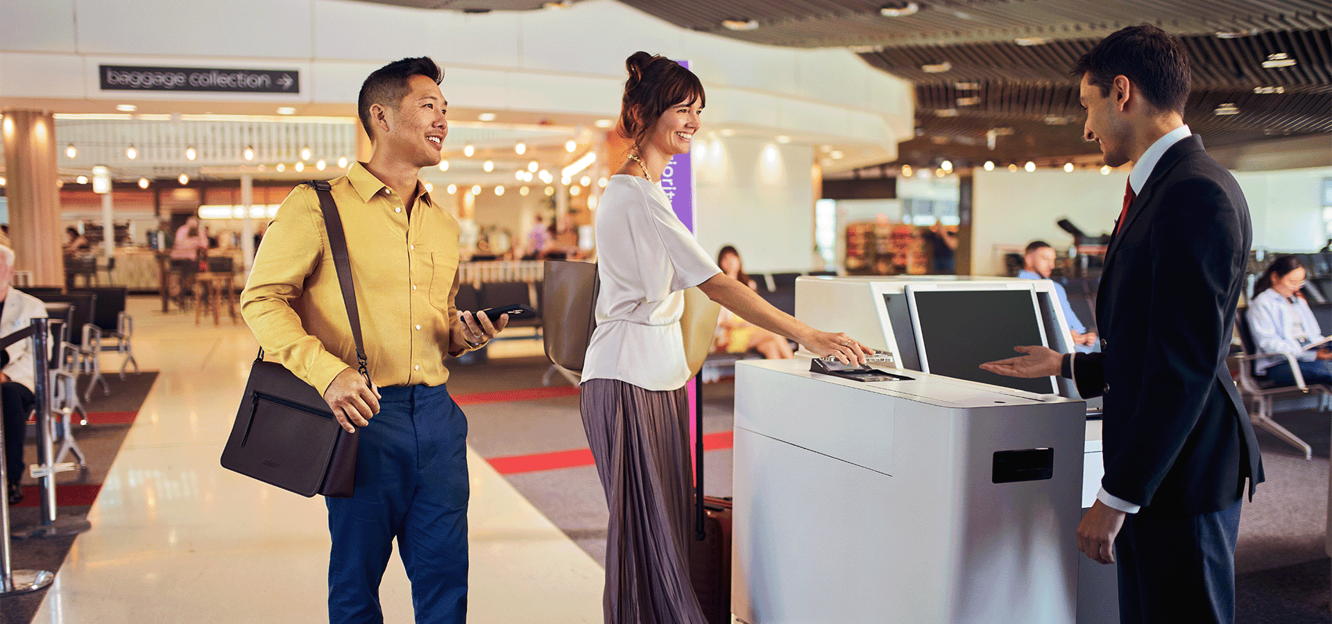 Travellers scanning boarding pass at boarding gate with Virgin Australia guest agent
