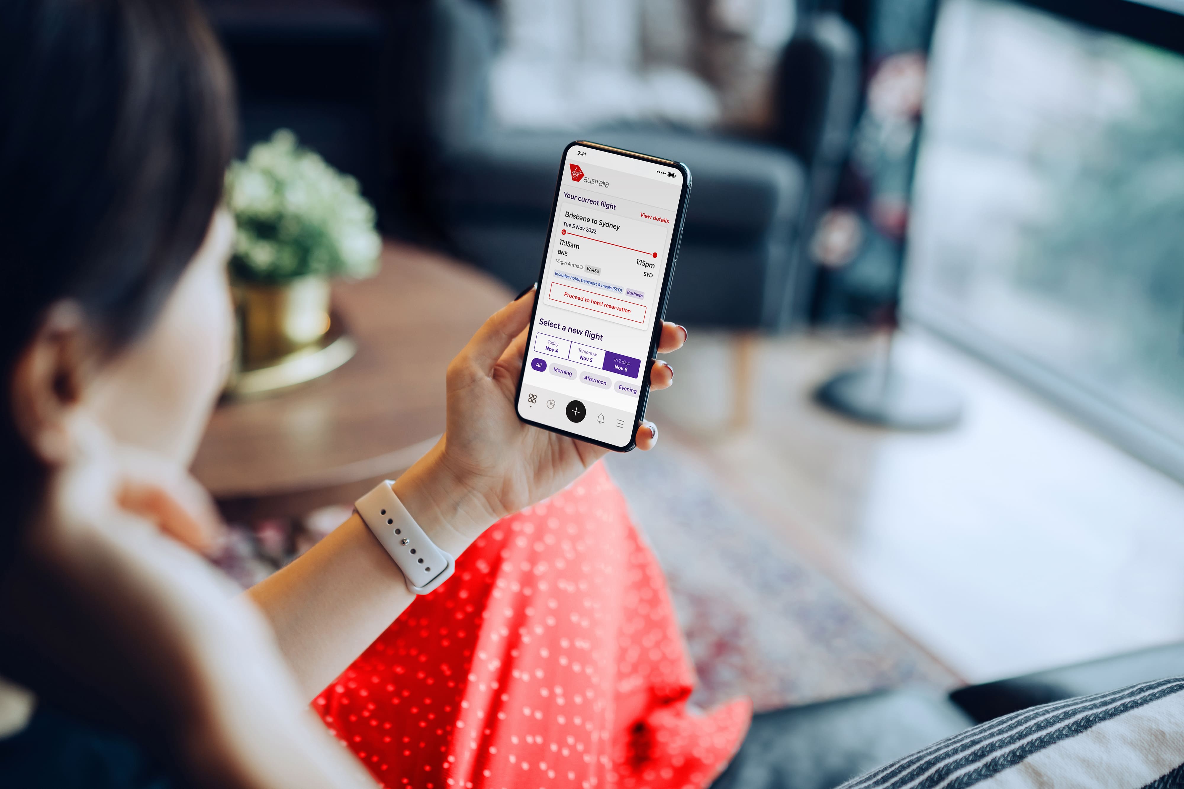 Customer looking down on phone for information on Rapid Rebook self-service tool