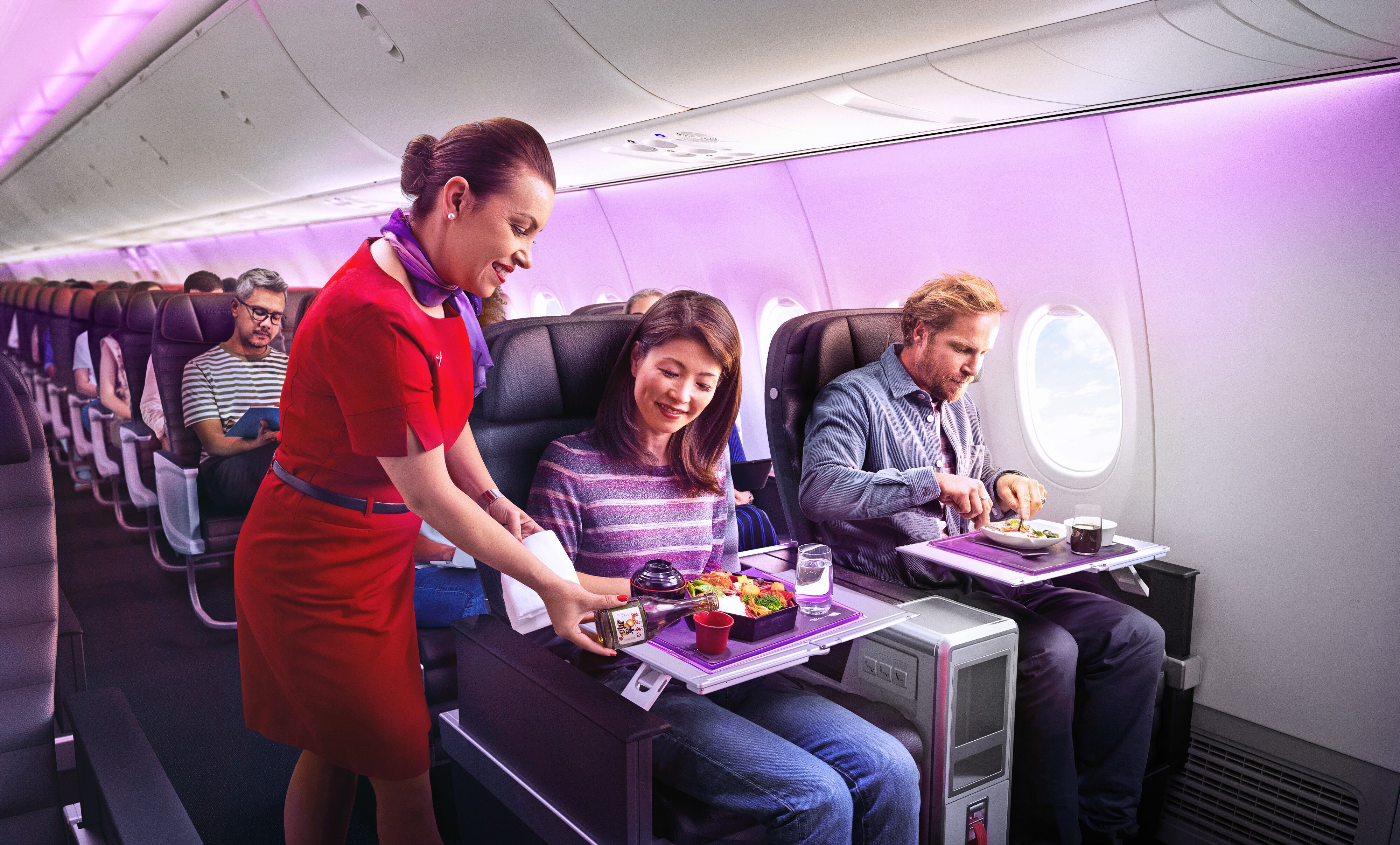 Passengers travelling in Business Class cabin on Virgin Australia flight receiving meals