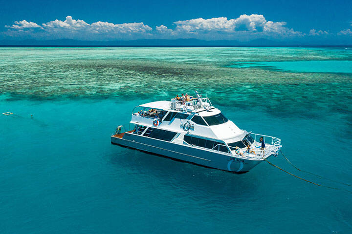 Aerial view of guests relaxing on the Ocean Freedom boat moored at Upolu Reef
