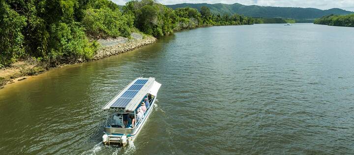 Aerial view of the Solar Whisper Wildlife and Crocodile Cruise boat, heading up the Daintree River