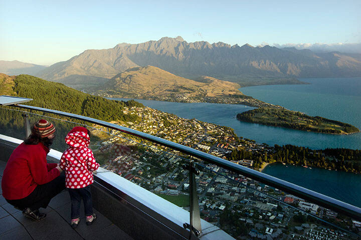 Mother and daughter looking at the scenic view of Queenstown 