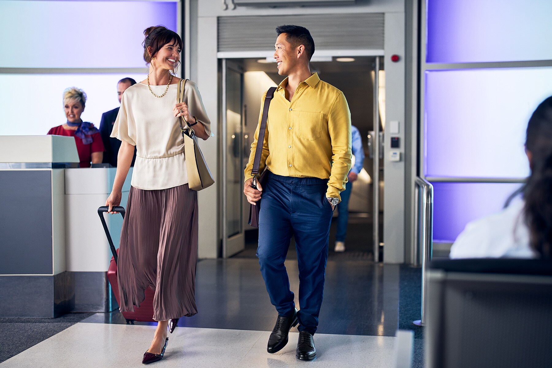 Businss map sitting at the airport lounge, with his laptop and food in front of him, phone in hand.